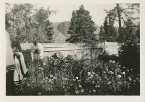 Image of Mrs. Hettasch in garden and boy taking picture
